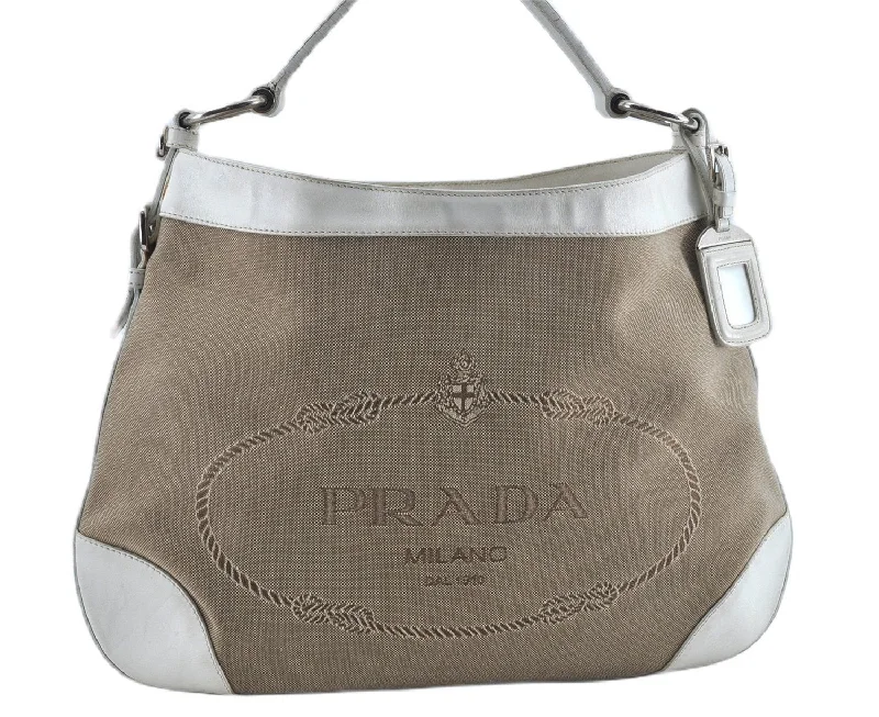 Prada tote bags with a printed Prada logo on the front for brand visibilityAuthentic PRADA Canvas Leather Nappa Shoulder Hand Bag Brown White J8129