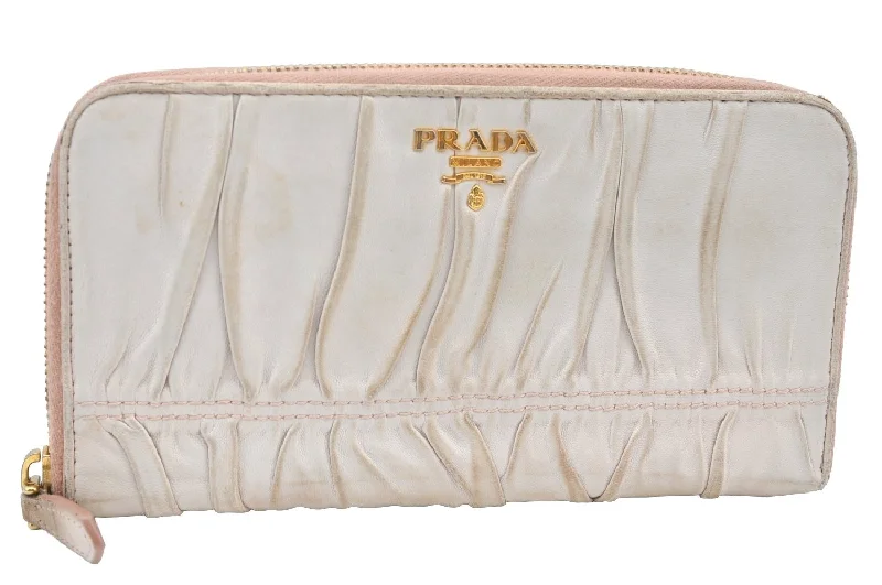 Prada Cahier bags featuring the signature triangular logo plaqueAuthentic PRADA Vintage Leather Round Zip Long Wallet Purse Pink K5471